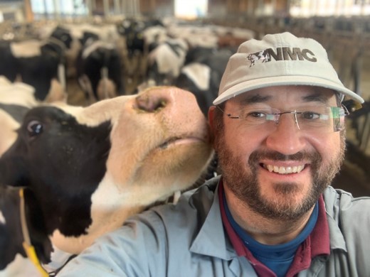 Zoetis livestock veterinarian posing for selfie with cow